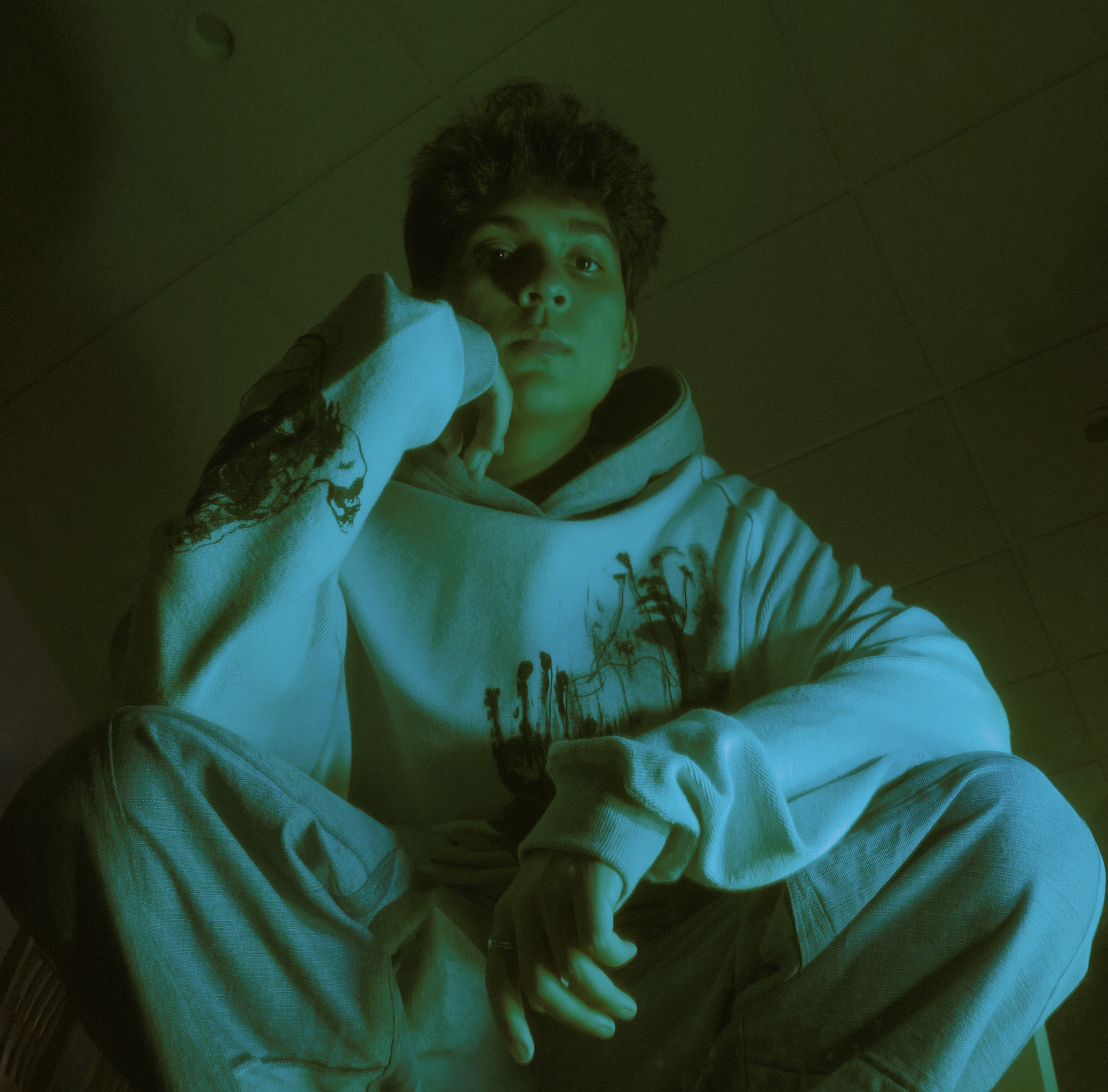 LUV DISK seated under cyan and green lighting